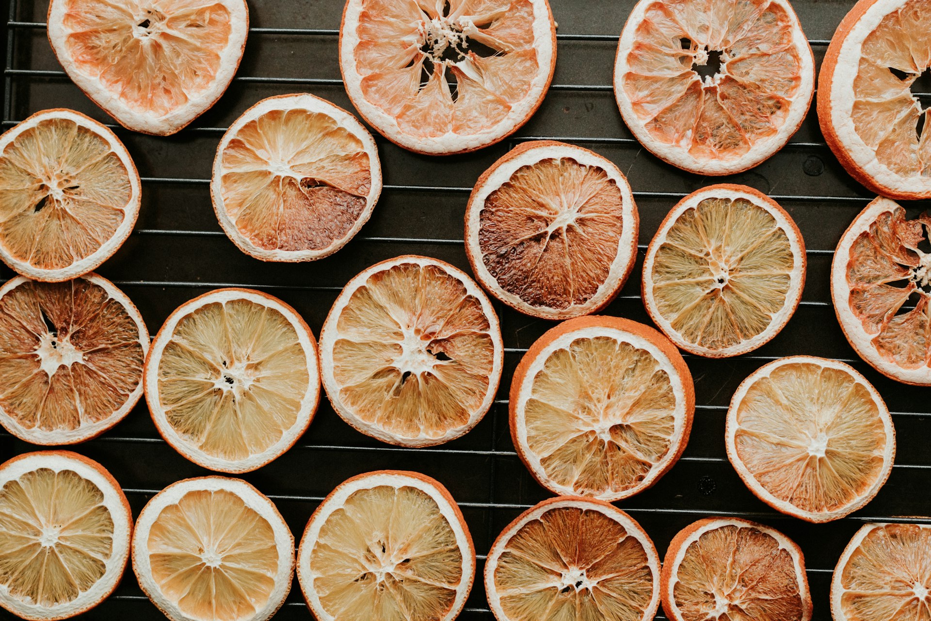 a bunch of oranges that are on a grill